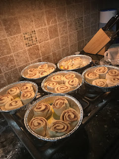 uncooked cinnamon rolls in round cake pans