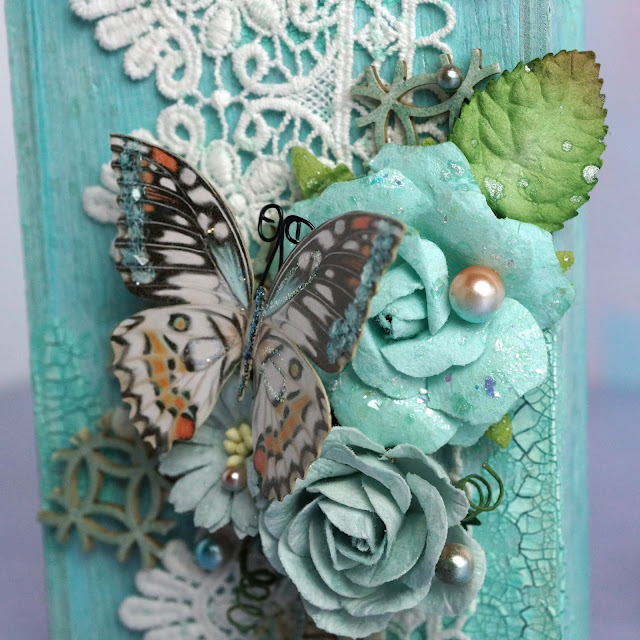 mixed media project made with Reneabouqets butterfly, chipboard, beautiful beads pearls, lace, paper flowers; Tim Holtz Distress Spray Stain salvaged patina and speckled egg, Distress Oxide Spray, Distress Glaze weathered wood; Scrapbook.com Pops of Color seafoam; Prima Marketing flower