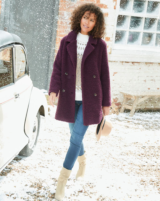 model wearing Cotton Traders borg coat walking in snow