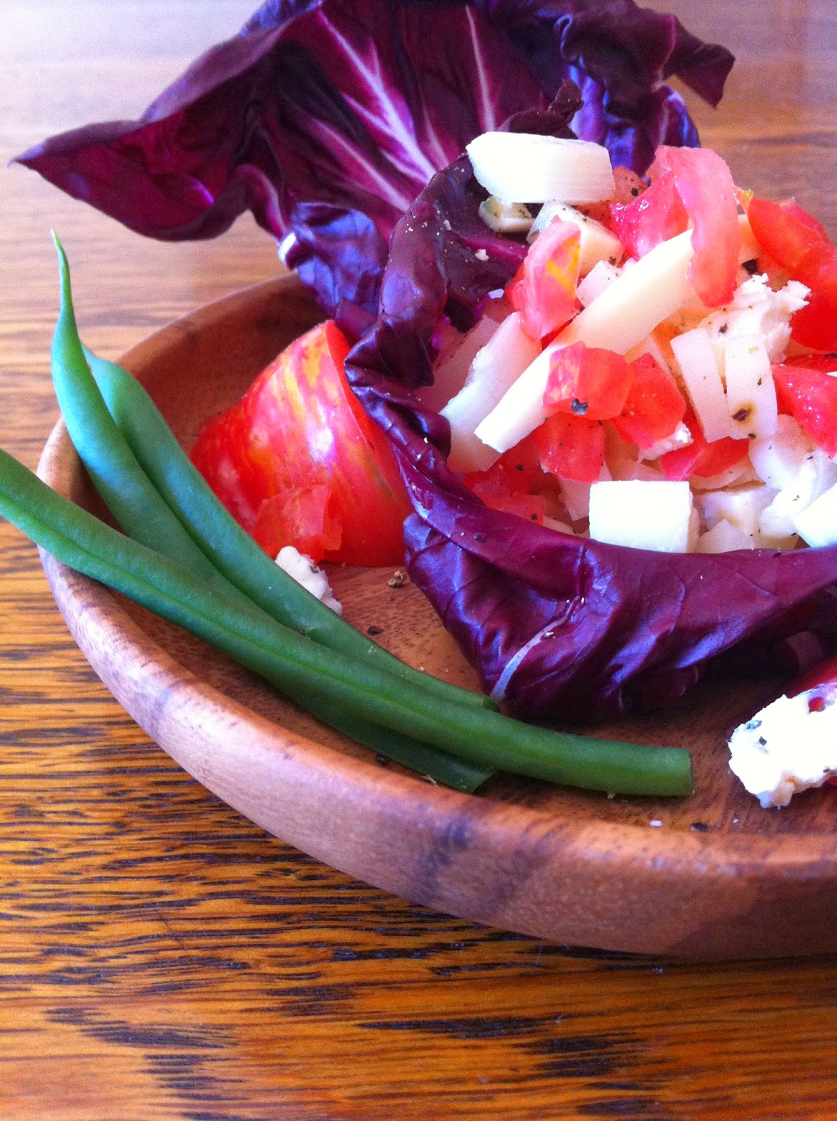 Radicchio Leaf Nest with Hearts of Palm and Heirloom Tomatoes Salad