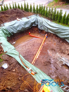 Puting drain pipes in pool excavation