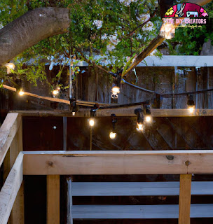 Image: String lights hanging above a garden seating area