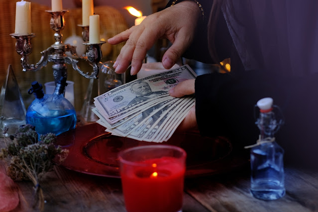 What is the candle with money inside