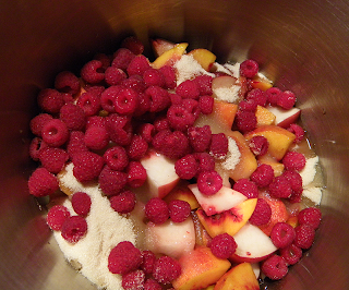 Pot filled with Peaches, Raspberries, Raw Sugar and Shot of Lemon