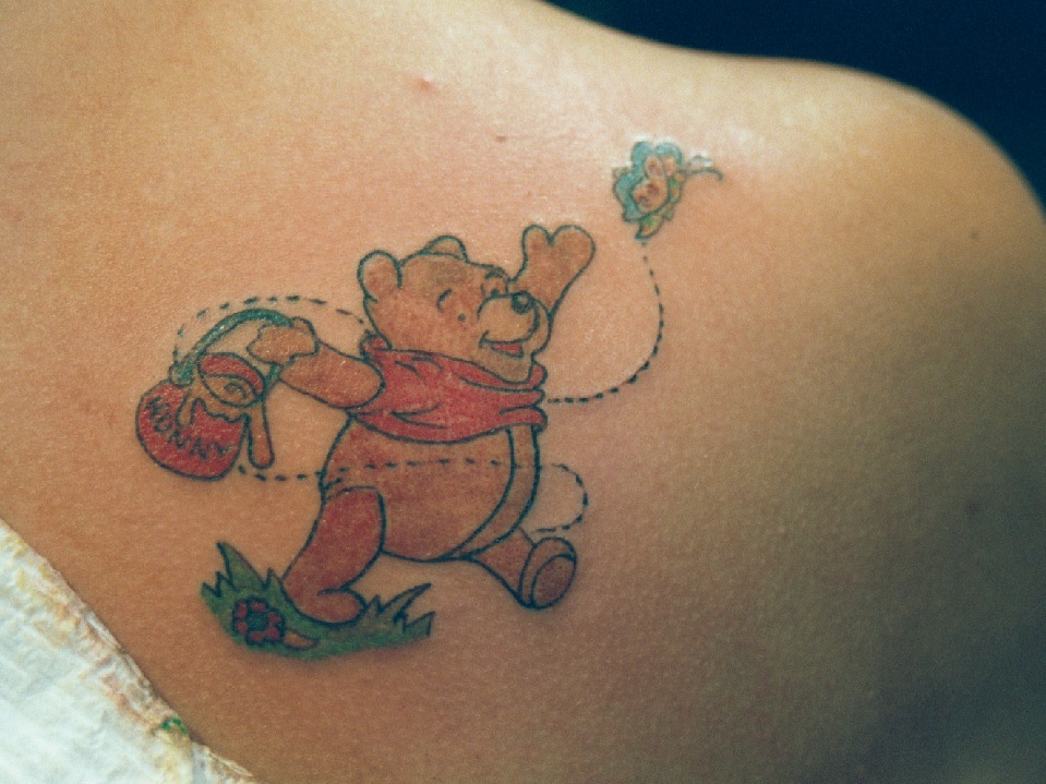 Winnie The Pooh and butterfly tattoo.