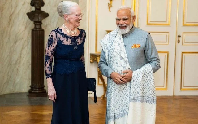 Crown Princess Mary wore a grey cape sleeve silk gown by Valentino. Danish Prime Minister Mette Frederiksen