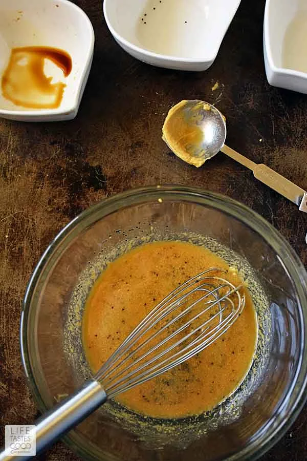 Whisking buttery Dijon mustard glaze for oven baked ham and cheese sliders recipe