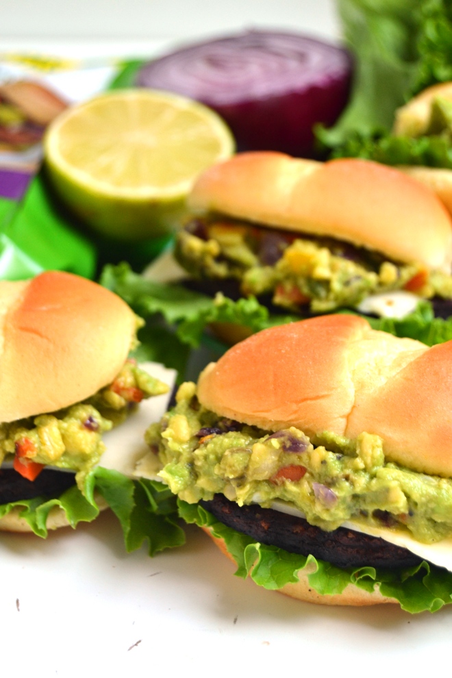  Mini Loaded Black Bean Burgers are packed with spicy black bean burgers, homemade grilled veggie loaded guacamole and pepper jack cheese all on slider buns and ready in just 10 minutes! www.nutritionistreviews.com