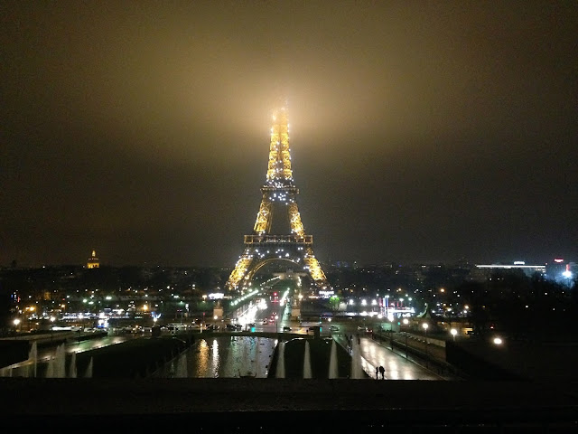 the eiffel tower at night in paris, france during light show