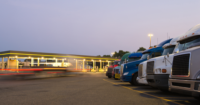 Truckers at gas station using ExpressIFTA for IFTA fuel tax reporting