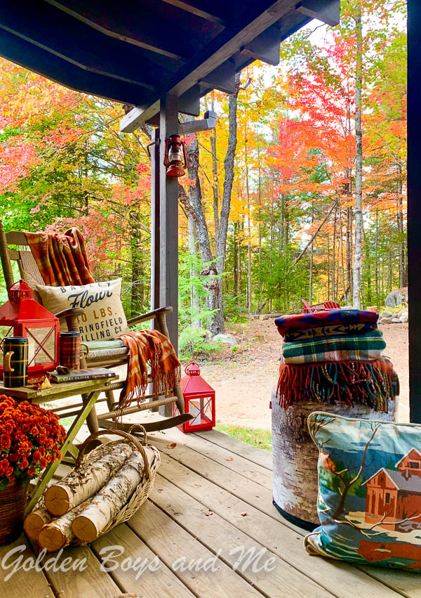 Porch with rustic fall decor at a mountain cabin with fall foliage. - www.goldenboysandme.com