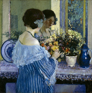 Frederick Carl Frieseke Girl in Blue Arranging Flowers