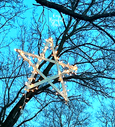 bright sky hanging star Christmas lights trees