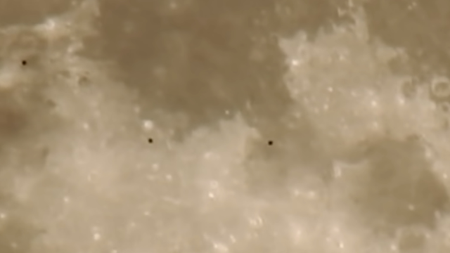 UFO orbs in black filmed flying 60 miles above the Moon's surface 2 to 3 miles wide.