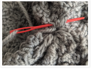 Continue working running/basting stitches and tugging on your yarn till you have a perfectly closed circle