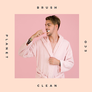 a white man in a pink dressing gown brushing his teeth