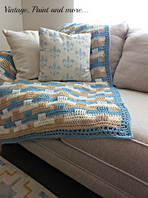 a crochet afghan using a basket weave pattern and DIY drop cloth pillow stenciled with craft paint