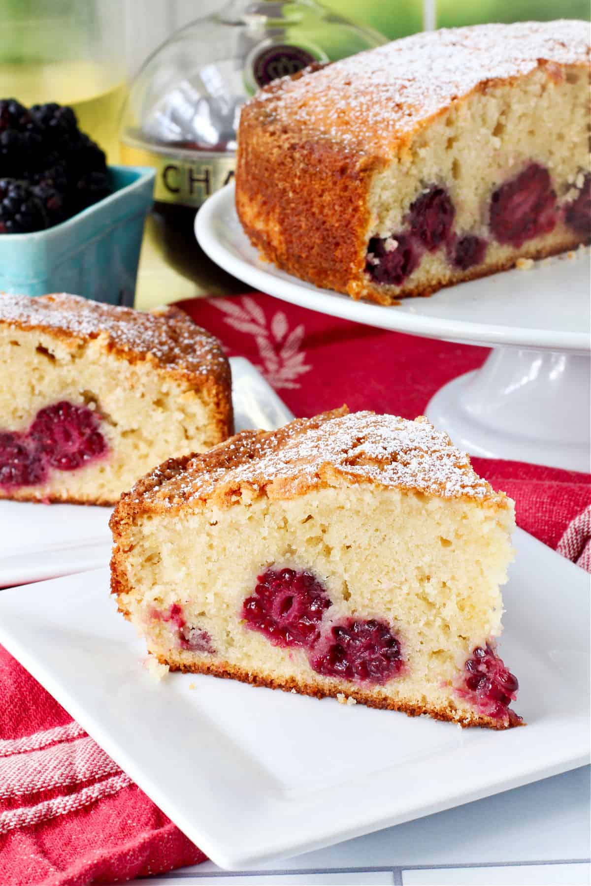 French Berry Cake slice on a square white cake.