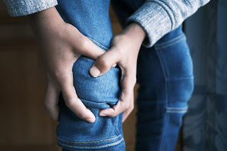 A man holding his knee | Chiros Ann Arbor