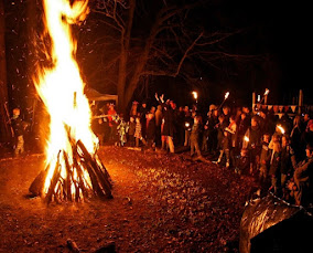 crowd gathers around fire during wassail