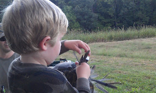 Kid stuffing dove feathers in a hat