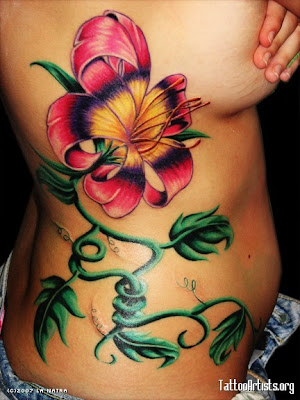 waves-and-flowers-lower-back-tattoo.jpg flower tattoo