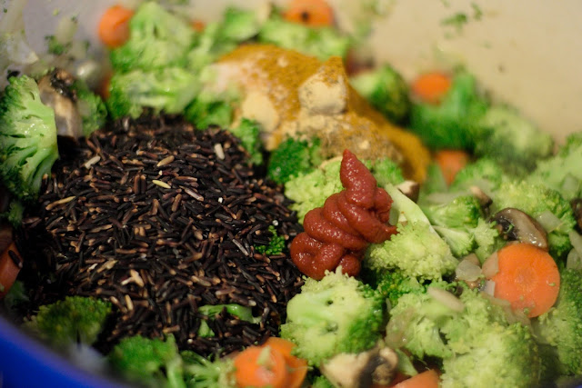 Rice, spices, and tomato paste in the pot.