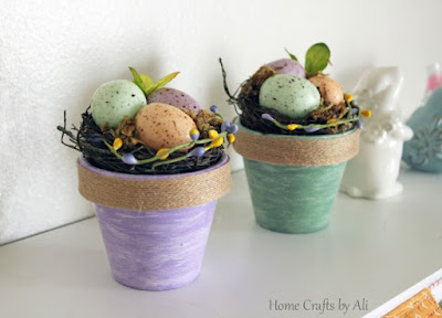 Springtime decorations of painted flower pots with egg nests
