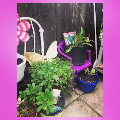 children's outdoor chairs and milk crates help build veritical space for a container garden