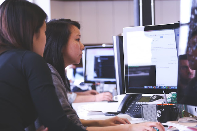 Women working together at a computer