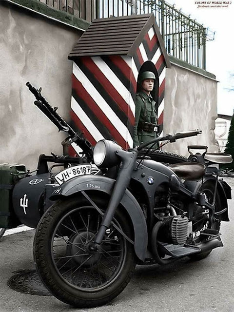 A German sentry in France circa 1941 with his BMW R75 motorcycle, worldwartwo.filminspector.com