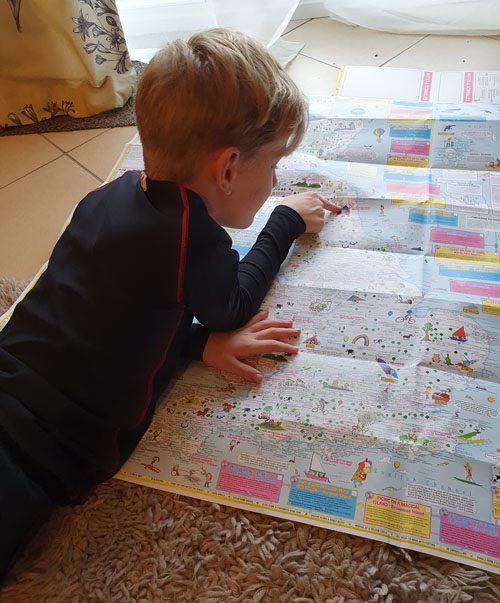 9 year old reading his map of adventures