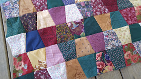 Tumbler quilt made with ugly fabrics