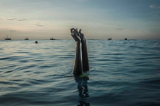 Woman in water with arms raised snapping fingers