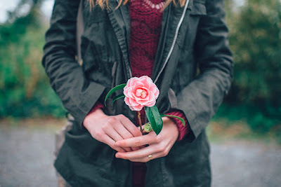 woman holding a rose