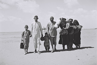 A Yemenite family walking through the desert to a reception camp