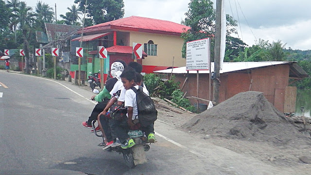 students riding the habal-habal on their way home at Calbiga Samar