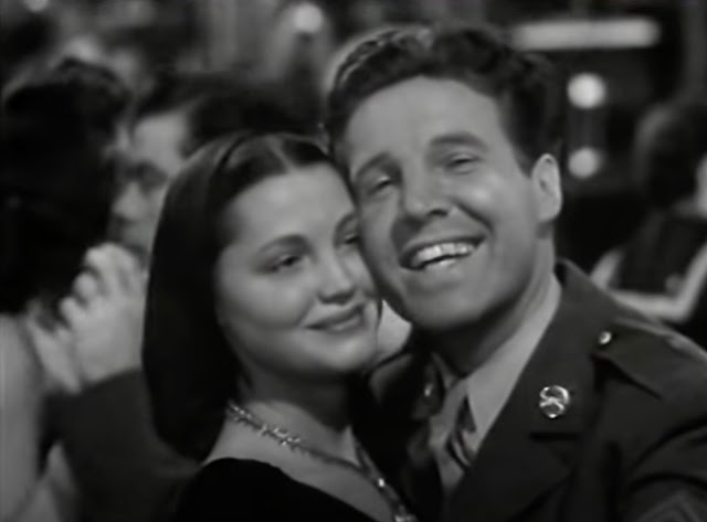 Screenshot from a Warner Brothers movie short of Ozzie Nelson and his Orchestra where he is dancing with a woman who is not Harriet Nelson