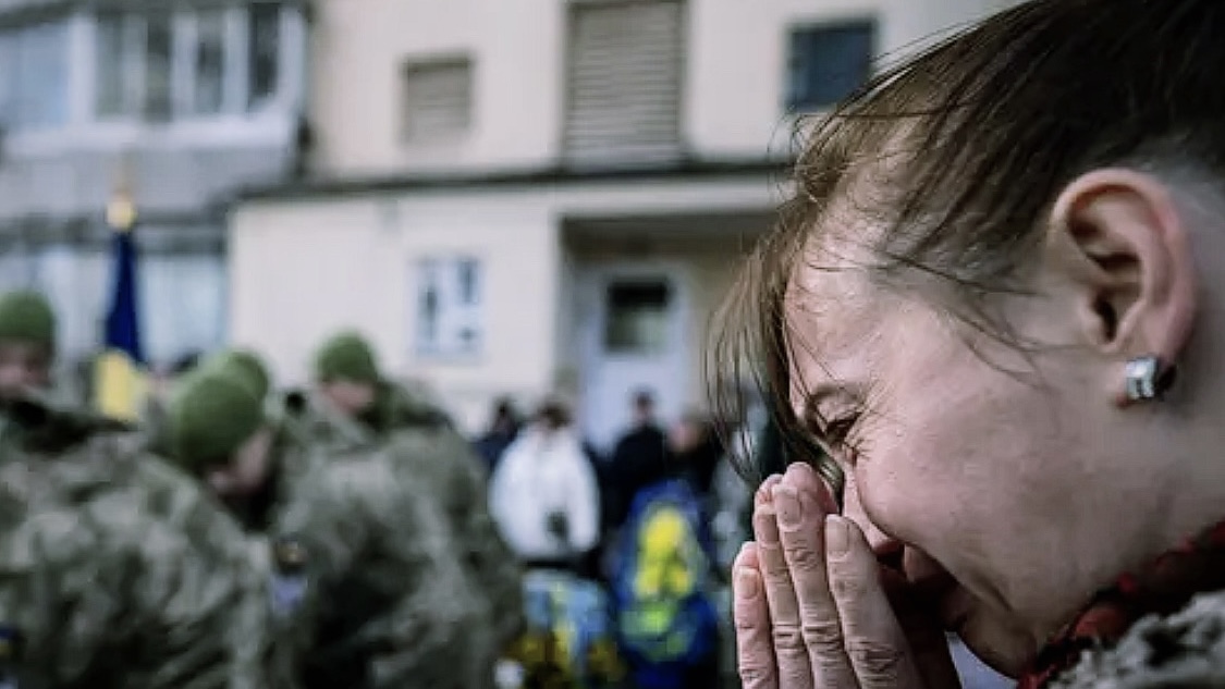 A woman cries at a senior Ukrainian lieutenant's funeral in Kyiv on Feb. 28, 2023. He was killed in a fight with Russian forces.  (AP Photo/Evgeniy Maloletka)