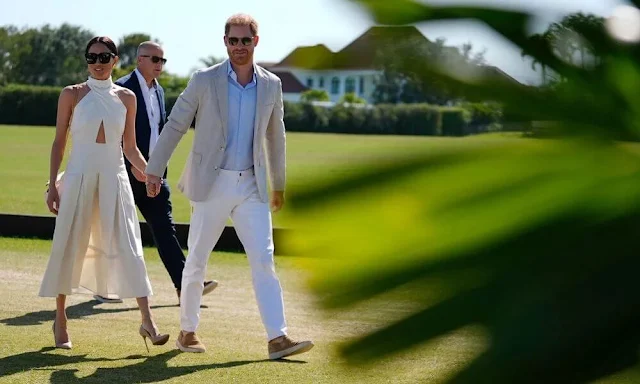 Meghan Markle, Duchess of Sussex wore an ivory silk ginger dress by Heidi Merrick at the Royal Salute Polo Challenge