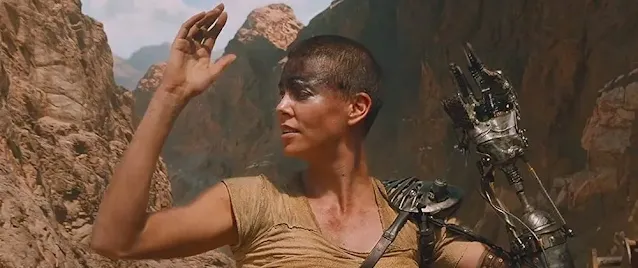 How did Furiosa lose her arm and need a mechanical replacement in Mad Max?