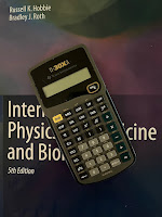 A TI-30 electronic calculator, superimposed on the cover of Intermediate Physics for Medicine and Biology.