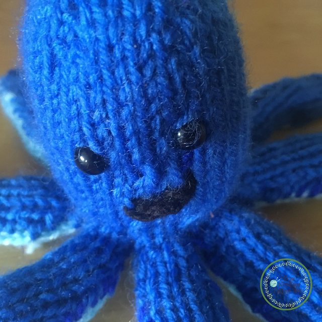 Picture of close up of the head and tentacles on knitted soft toy octopus