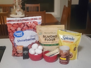 photo of recipe ingredients: frozen strawberries, almond flour, sweetener, almond flavoring, eggs, butter, baking powder