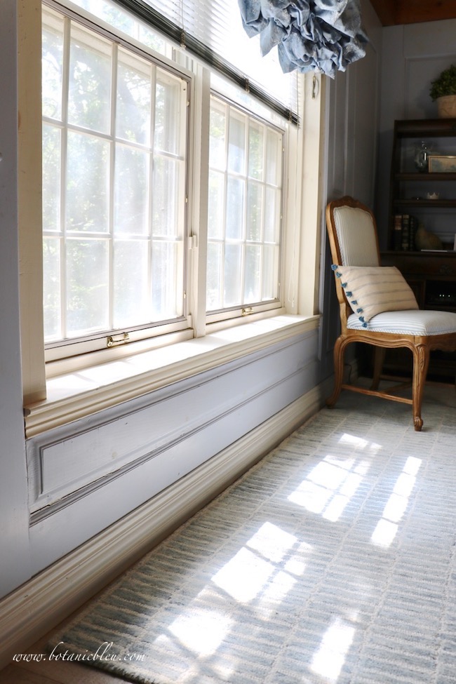 Stock moulding was selected to support the windowsill and is the exact depth of the custom French Country wood paneling