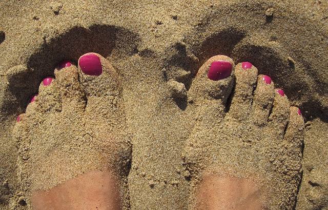 Polished Toe Nails in the Sand 