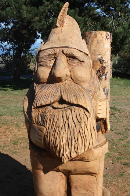 Rough wood carving of a Tolkien dwarf