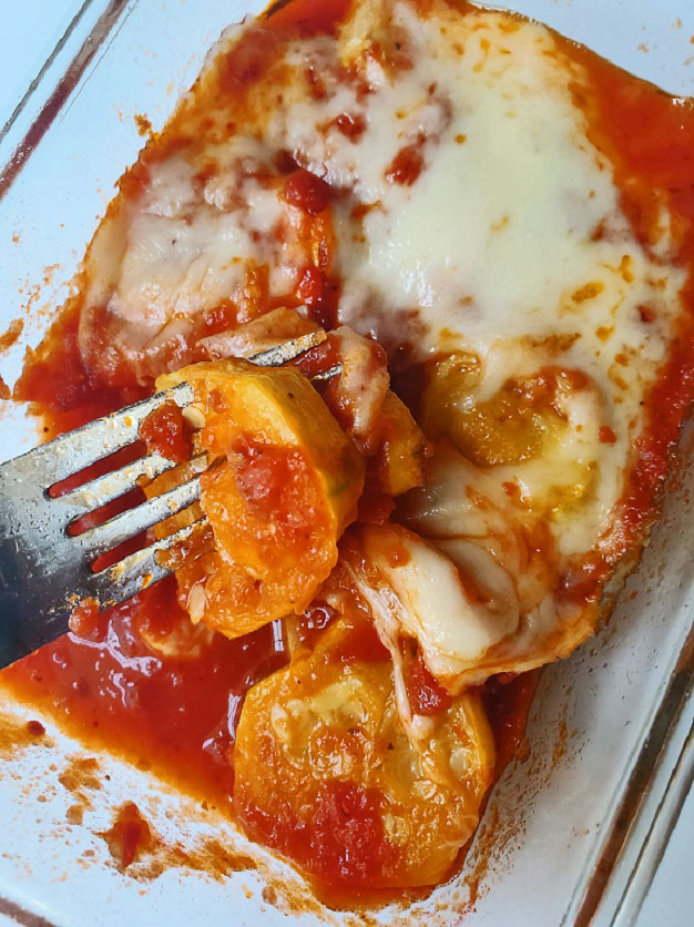 zucchini in tomato sauce  with cheese melted on top