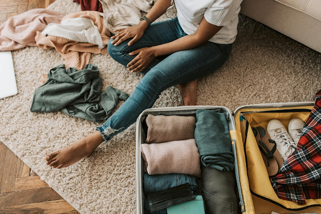 https://www.pexels.com/photo/a-woman-packing-her-suitcase-7365311/