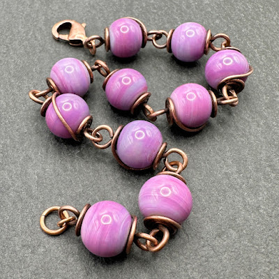 Handmade lampwork glass and copper wirework bracelet by Laura Sparling